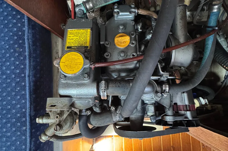 Slide: The Image of Engine compartment of a 1989 Ericson Sloop sailboat, showcasing mechanical components. - 42