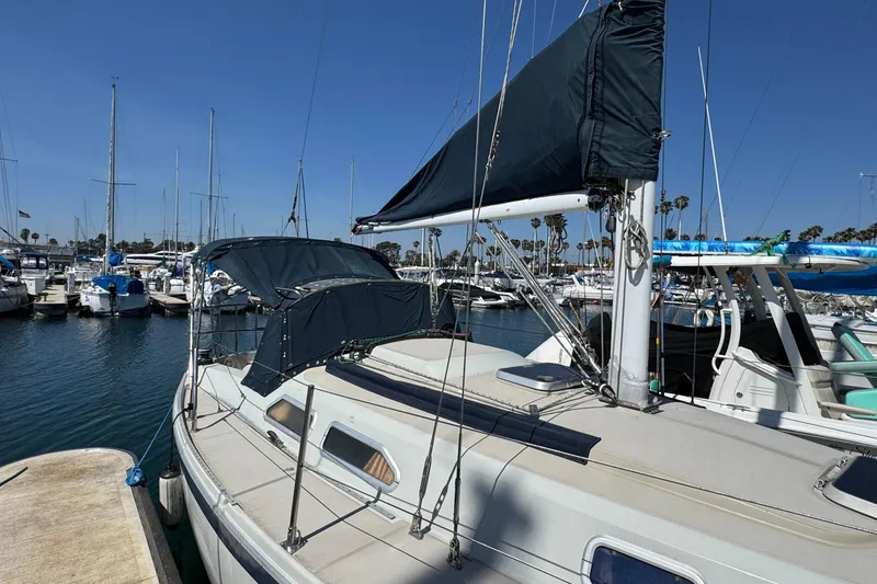 Slide: The Image of 1989 Ericson Sloop sailboat docked in a marina under clear blue skies. - 5