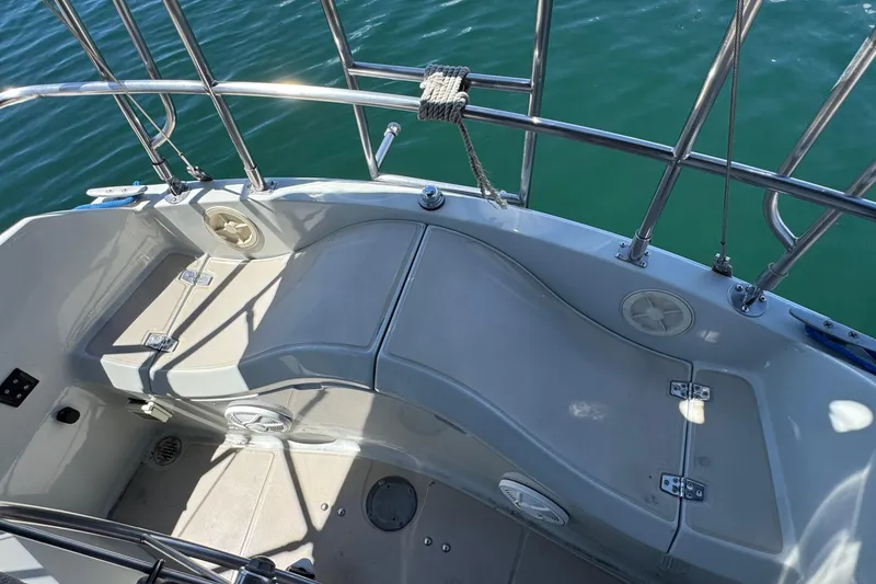 Slide: The Image of Cockpit of 1989 Ericson Sloop sailboat with seating and stainless steel railings. - 9