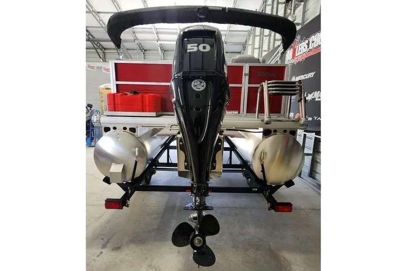 Slide: The Image of 2026 Sun Tracker Party Barge 16 DLX pontoon boat with 50 HP engine in a garage. - 4