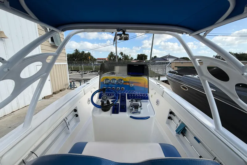 Slide: The Image of Interior view of 2006 Concept 30 PF Open Fish boat with blue accents and control panel. - 12