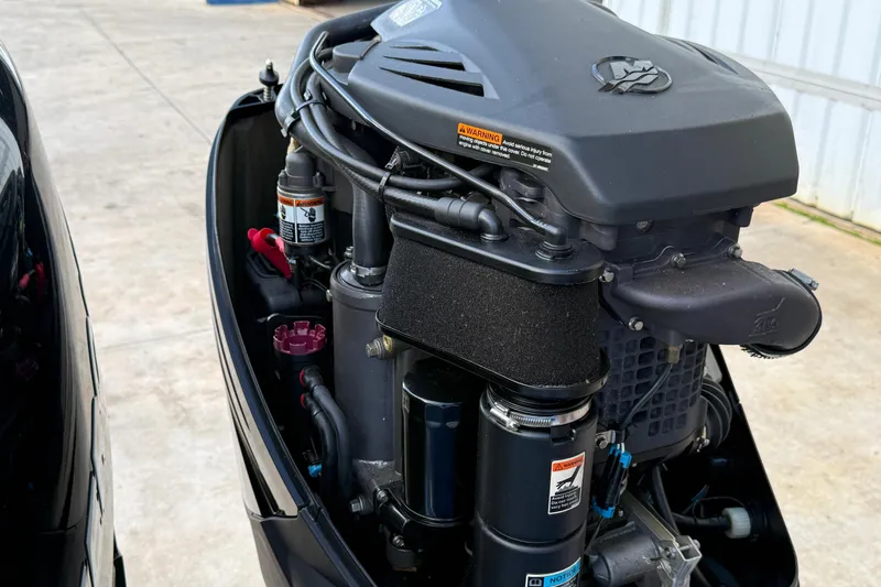 Slide: The Image of Close-up of a 2006 Concept 30 PF Open Fish boat engine, showcasing intricate components. - 15