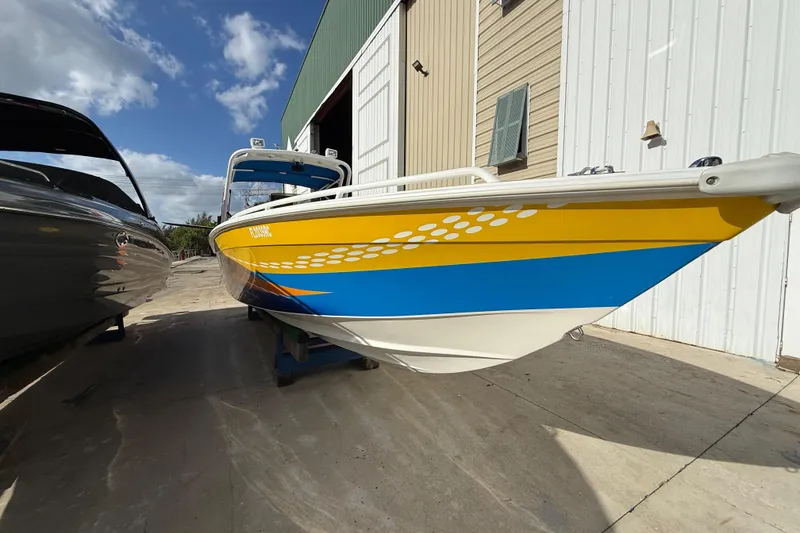 Slide: The Image of 2006 Concept 30 PF Open Fish boat with vibrant yellow and blue design, docked outdoors. - 3