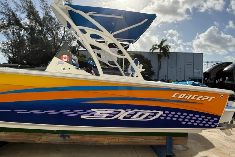 Slide: The Image of 2006 Concept 30 PF Open Fish boat with vibrant orange and blue design, docked outdoors. - 4