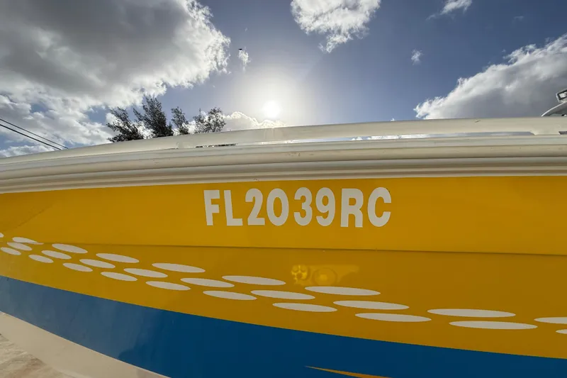 Slide: The Image of Yellow 2006 Concept 30 PF Open Fish boat with registration FL2039RC under a cloudy sky. - 6
