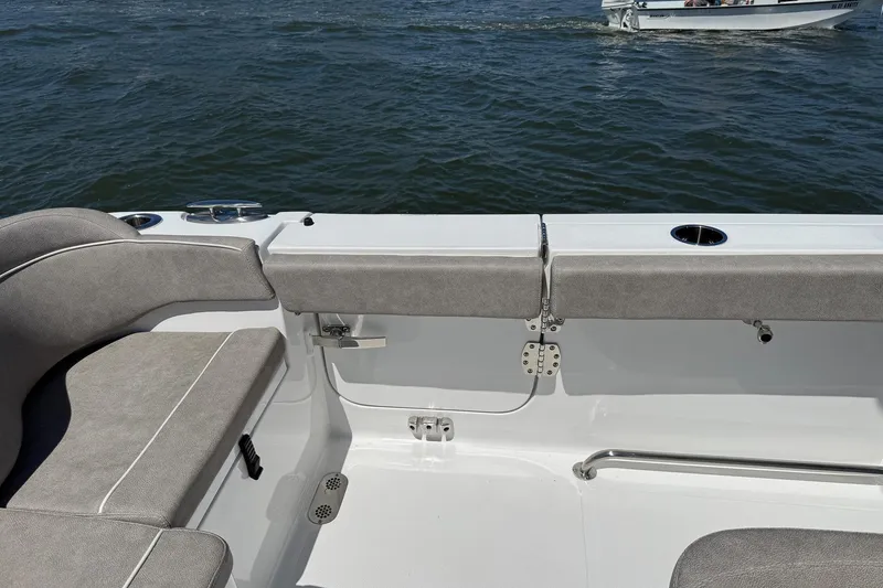 Slide: The Image of 2025 Sea Hunt Ultra 275 SE boat interior with cushioned seating and ocean view. - 13