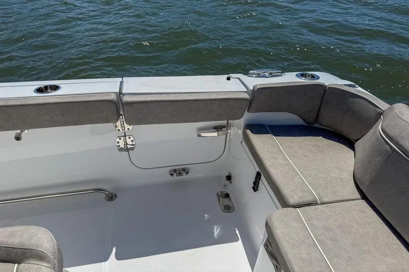 Slide: The Image of 2025 Sea Hunt Ultra 275 SE boat interior with cushioned seating and ocean view. - 15