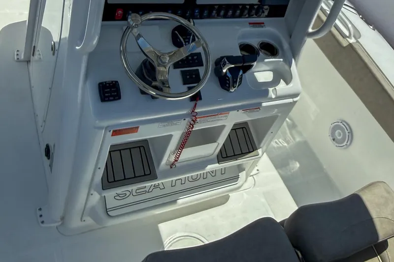 Slide: The Image of 2025 Sea Hunt Ultra 275 SE boat console with steering wheel and controls. - 21