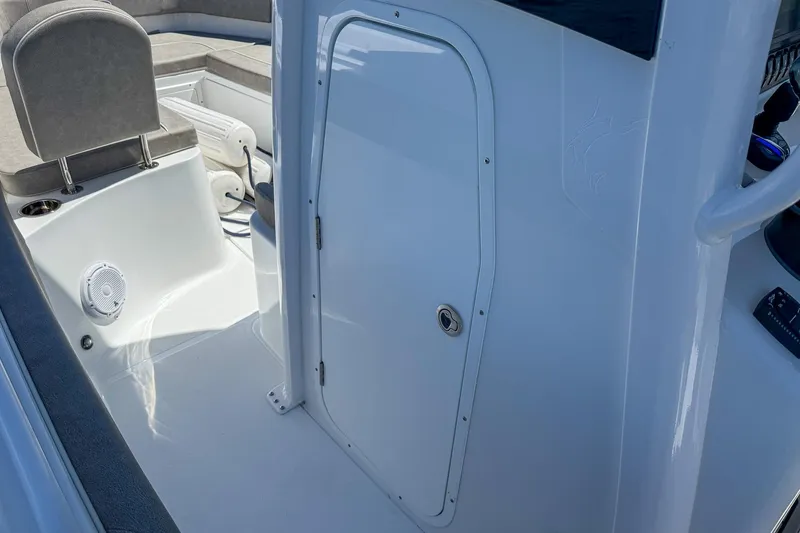 Slide: The Image of 2025 Sea Hunt Ultra 275 SE boat interior with seating and storage compartment. - 30