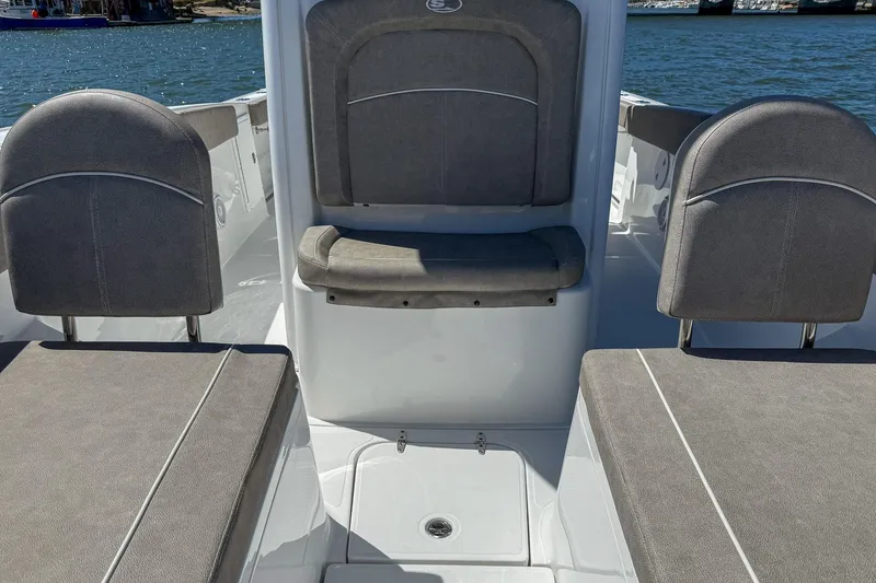 Slide: The Image of 2025 Sea Hunt Ultra 275 SE boat interior with gray seating and ocean backdrop. - 34