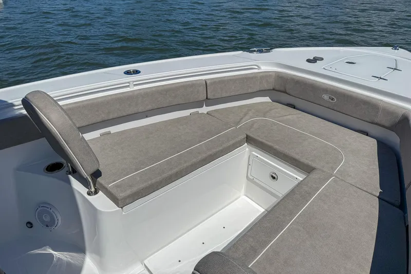 Slide: The Image of 2025 Sea Hunt Ultra 275 SE boat with spacious seating and storage on calm water. - 35