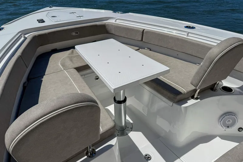 Slide: The Image of 2025 Sea Hunt Ultra 275 SE boat interior with seating and table on water. - 38