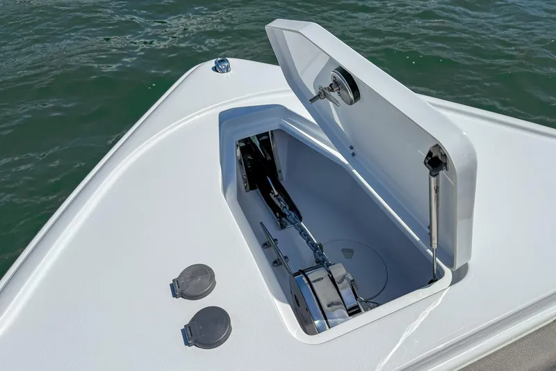 Slide: The Image of Anchor compartment of 2025 Sea Hunt Ultra 275 SE boat, open on calm water. - 50