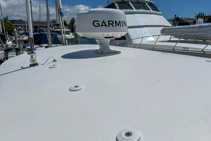 Slide: The Image of 2025 Sea Hunt Ultra 275 SE boat with Garmin radar, docked in a marina. - 55