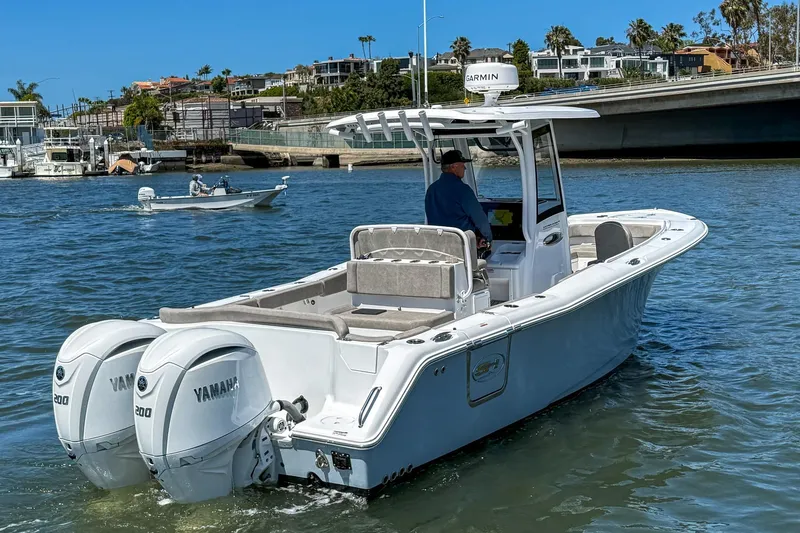 Slide: The Image of 2025 Sea Hunt Ultra 275 SE boat with dual Yamaha engines on the water. - 6