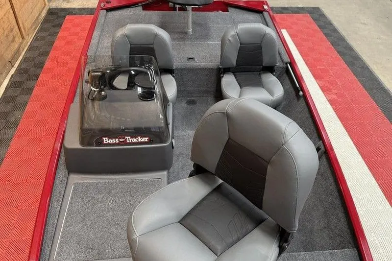 Slide: The Image of 2026 Tracker Bass Tracker Classic XL boat interior with gray seating and red accents. - 12