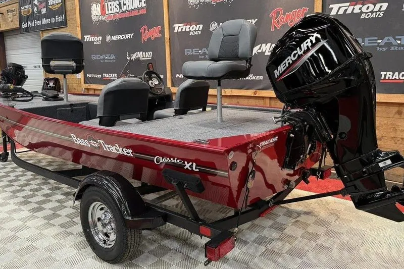 Slide: The Image of 2026 Tracker Bass Tracker Classic XL boat with Mercury engine on display. - 3