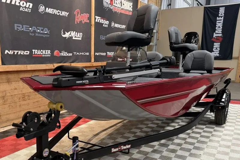 Slide: The Image of 2026 Tracker Bass Tracker Classic XL boat on display with Minn Kota trolling motor. - 9