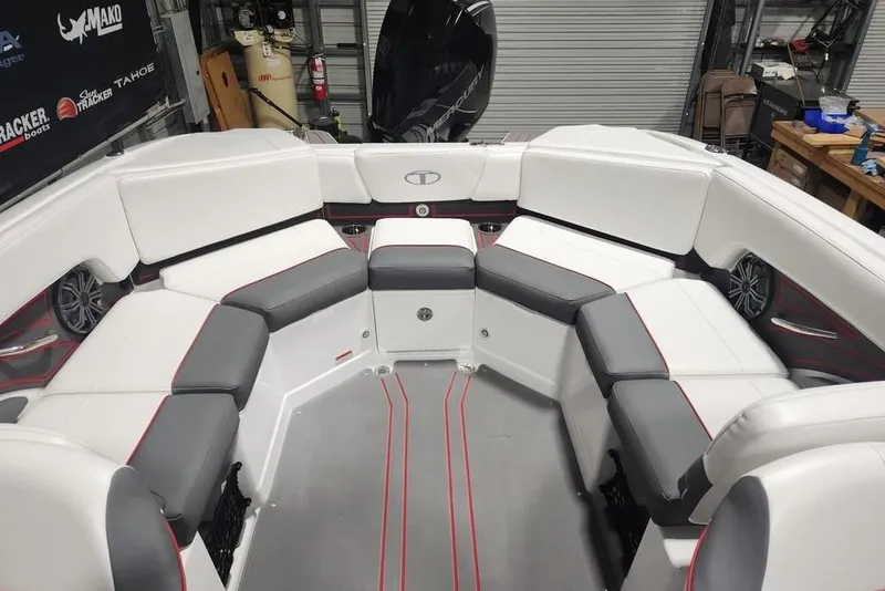 Slide: The Image of 2026 Tahoe 210 S boat interior with white and gray seating, red accents, and modern design. - 12