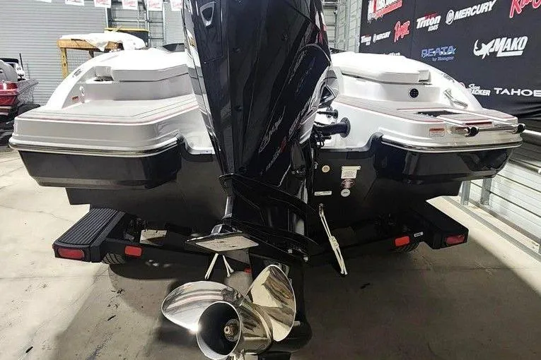 Slide: The Image of 2026 Tahoe 210 S boat with powerful outboard motor in showroom setting. - 3