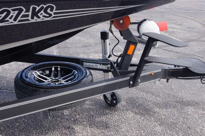 Slide: The Image of Trailer of 2022 Skeeter ZX225 boat with spare tire and step ladder. - 13