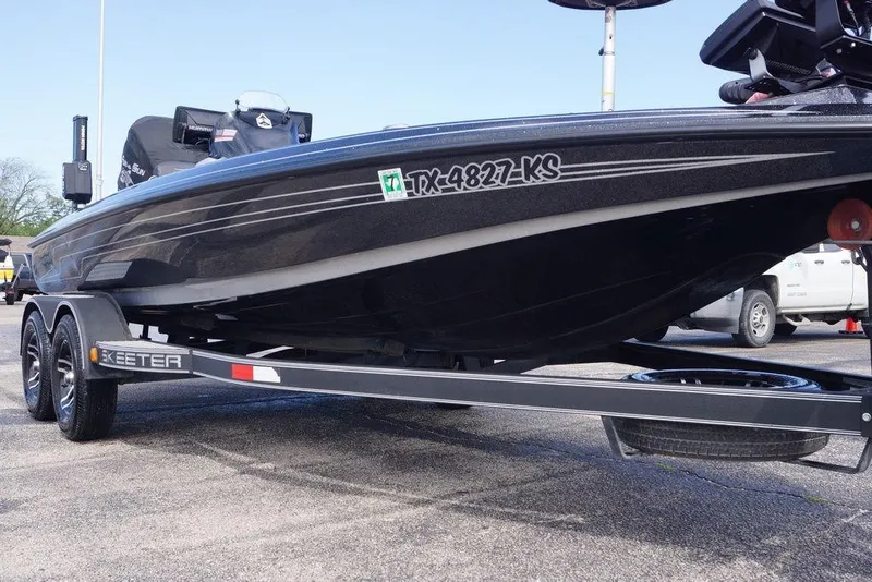 Slide: The Image of 2022 Skeeter ZX225 boat on trailer, side view with registration number visible. - 14