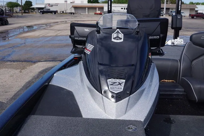 Slide: The Image of 2022 Skeeter ZX225 boat with Humminbird electronics, parked on a wet pavement. - 17