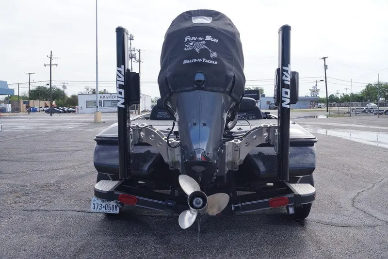 Slide: The Image of 2022 Skeeter ZX225 boat rear view with Talon anchors in parking lot. - 9