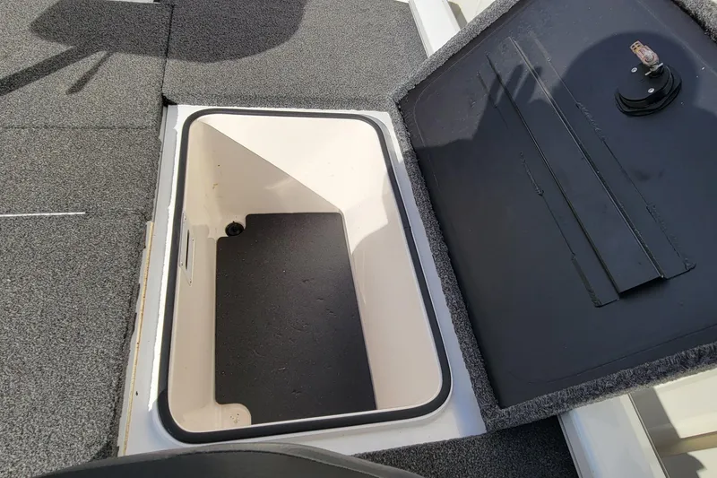 Slide: The Image of Open storage compartment in 2019 Vexus AVX1980 boat, showing interior details and debris. - 21