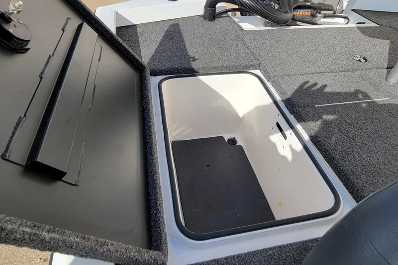 Slide: The Image of Open storage compartment on a 2019 Vexus AVX1980 boat, featuring a carpeted lid. - 22