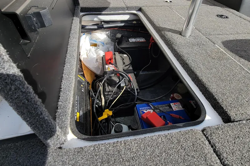 Slide: The Image of Open storage compartment in 2019 Vexus AVX1980 boat, featuring carpeted interior. - 23