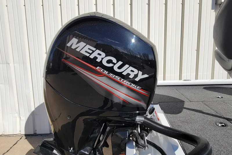 Slide: The Image of 2019 Vexus AVX1980 boat with cover, parked at Ted's Boatarama, featuring Mercury outboard motor. - 5