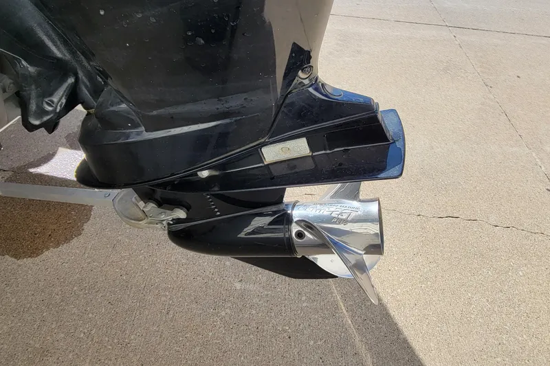 Slide: The Image of Close-up of a 2019 Vexus AVX1980 boat motor on a concrete surface. - 7