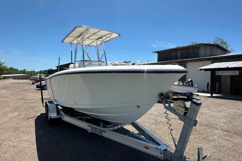 Slide: The Image of 2023 LFG 22 CC boat on trailer in sunny outdoor setting. - 10