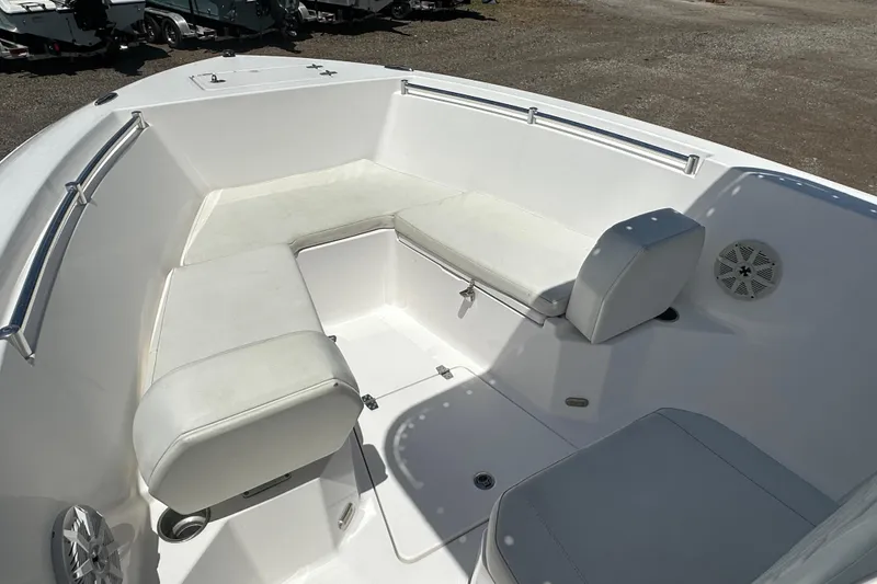 Slide: The Image of 2023 LFG 22 CC boat interior with white cushioned seating and stainless steel railings. - 11