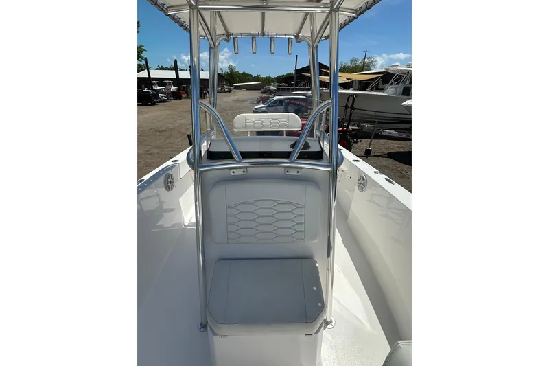 Slide: The Image of 2023 LFG 22 CC boat interior with seating and T-top under sunny skies. - 13