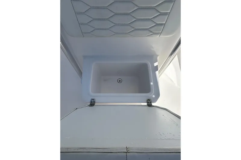 Slide: The Image of 2023 LFG 22 CC boat interior with open storage compartment. - 14