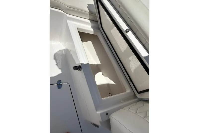 Slide: The Image of Open storage compartment on 2023 LFG 22 CC boat, featuring white interior design. - 18