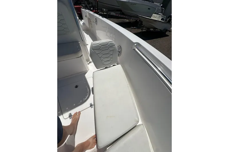Slide: The Image of 2023 LFG 22 CC boat interior with white seating and footrest. - 19