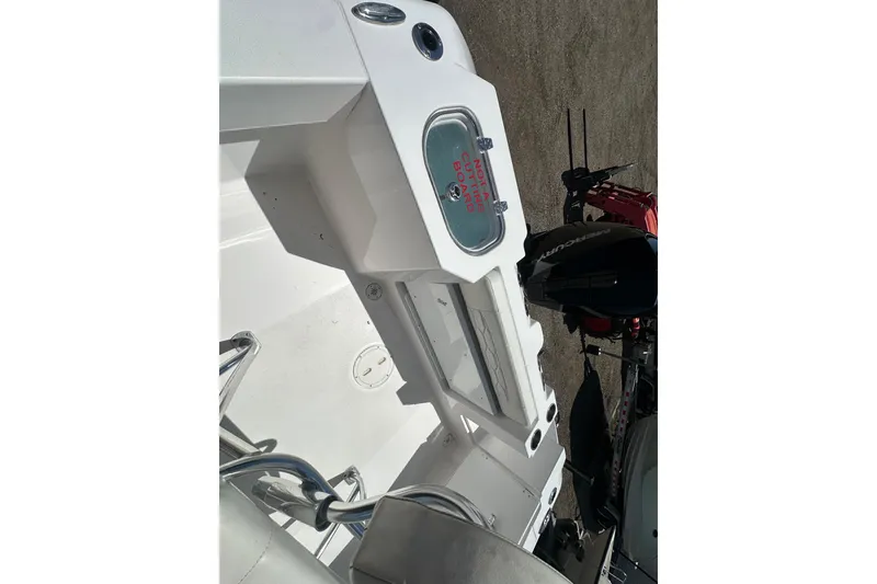 Slide: The Image of 2023 LFG 22 CC boat interior with storage compartments and Mercury outboard motor. - 23