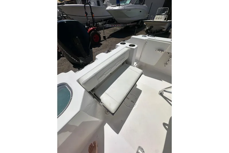 Slide: The Image of 2023 LFG 22 CC boat interior with foldable seating and cup holders. - 24