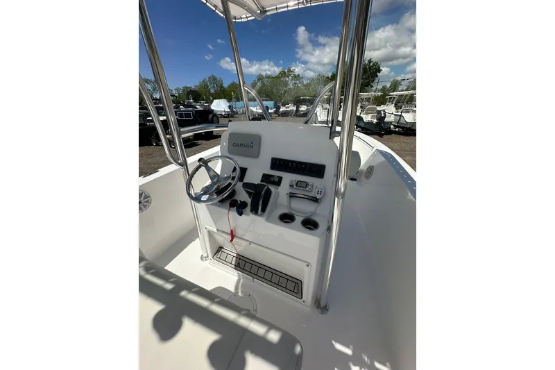 Slide: The Image of 2023 LFG 22 CC boat console with Garmin navigation, steering wheel, and controls. - 26
