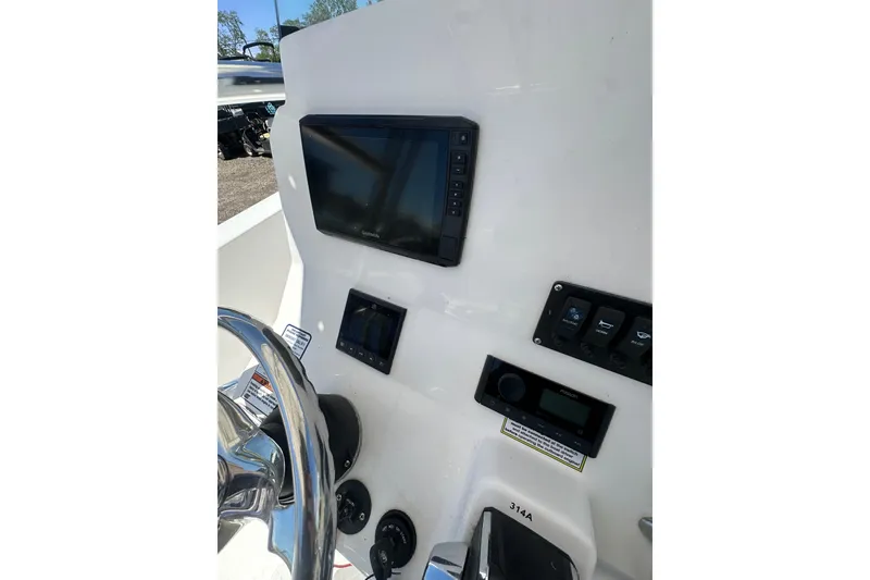 Slide: The Image of 2023 LFG 22 CC boat dashboard with steering wheel and electronic controls. - 27