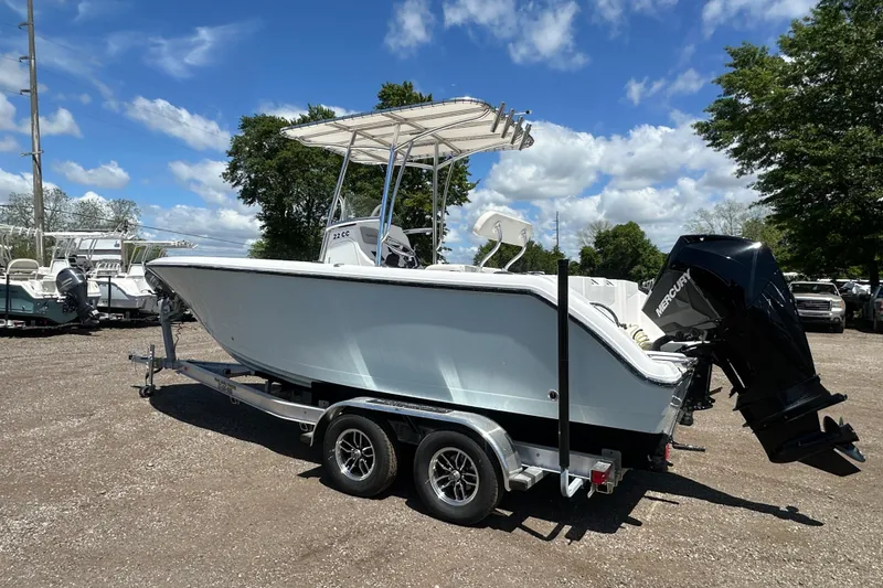 Slide: The Image of 2023 LFG 22 CC boat on trailer, parked outdoors under a clear blue sky. - 3