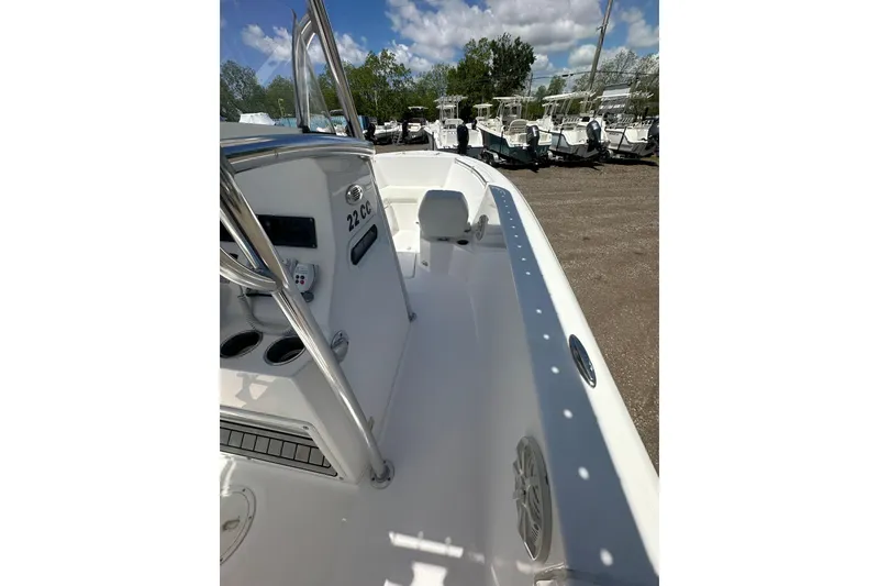 Slide: The Image of 2023 LFG 22 CC boat interior with console and seating, parked outdoors. - 30