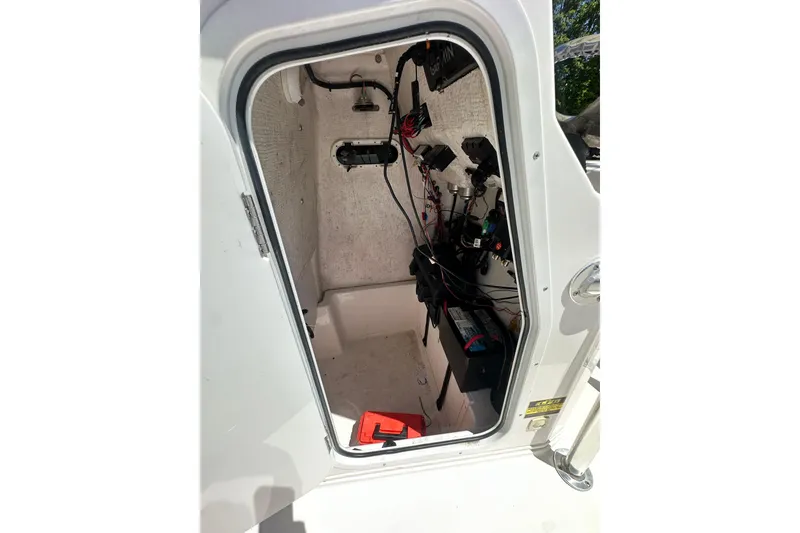 Slide: The Image of Interior view of 2023 LFG 22 CC boat's electrical compartment with wiring and equipment. - 31