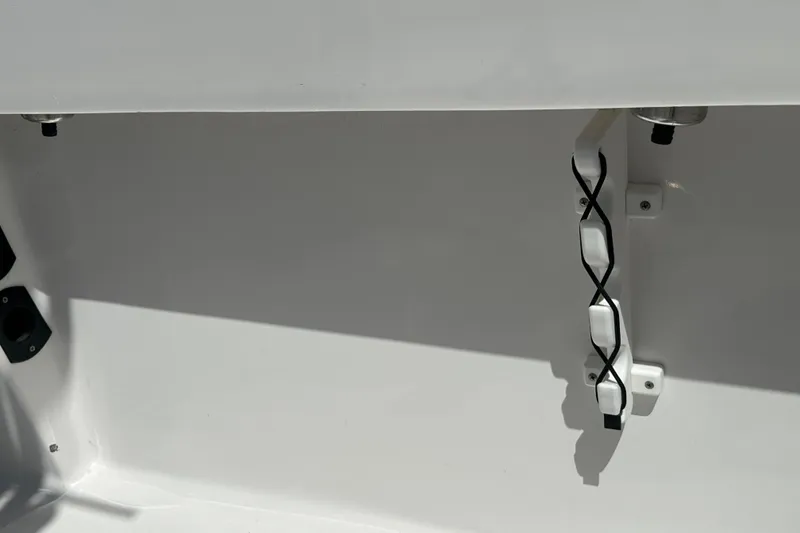 Slide: The Image of Interior view of 2023 LFG 22 CC boat, featuring a clean, white surface with mounted components. - 34