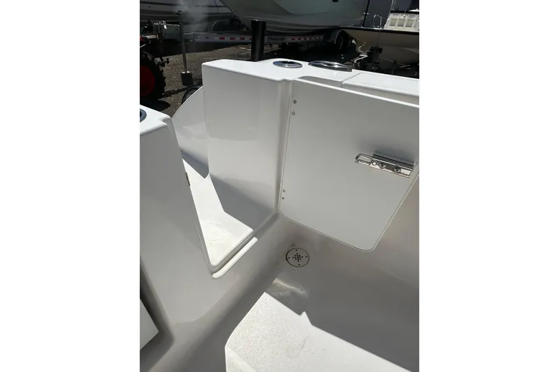 Slide: The Image of 2023 LFG 22 CC boat interior with storage compartment and cup holders. - 35