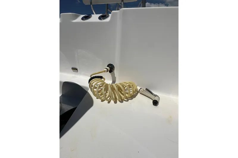 Slide: The Image of Coiled hose on 2023 LFG 22 CC boat deck under sunny sky. - 36