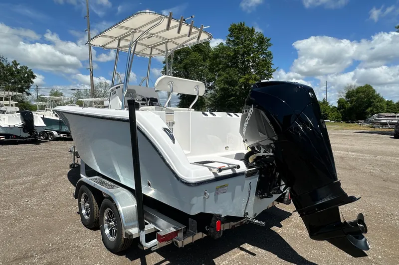 Slide: The Image of 2023 LFG 22 CC boat with Mercury outboard motor on trailer, under blue sky. - 4